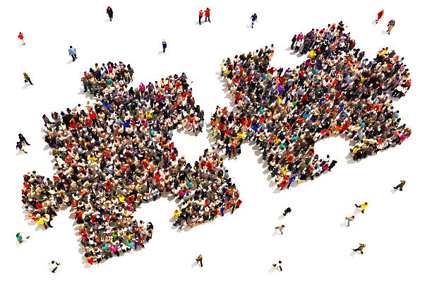 Large group of people in the shape of two puzzle pieces on a white background. (Talent Acquisition vs Recruitment blog)