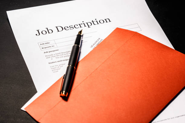 Job description and golden pen on the envelope for letters (Rewrite job description blog)