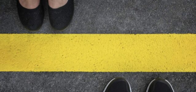 man and woman feet divided by yellow line