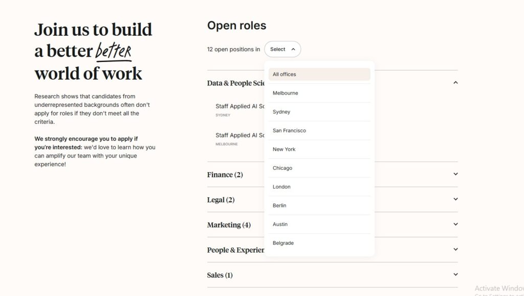 Left-side bold recruitment headline 'Join us to build a better world of work' with supporting text, right side shows 'Open roles' and a city list dropdown on a pale page.