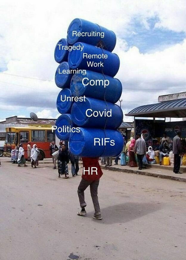 A person carries a tall stack of blue barrels labeled with workplace challenges like Covid, RIFs, Unrest, Politics, HR, Recruiting, Remote Work, Learning, and Comp.