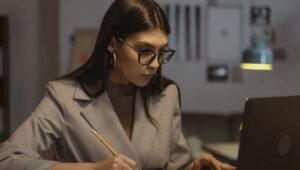 girl with glasses at laptop