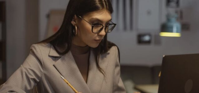 girl with glasses at laptop