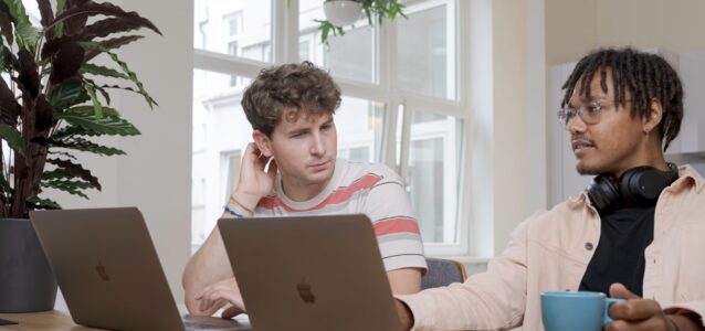 2 people sitting with laptops generative ai for hr