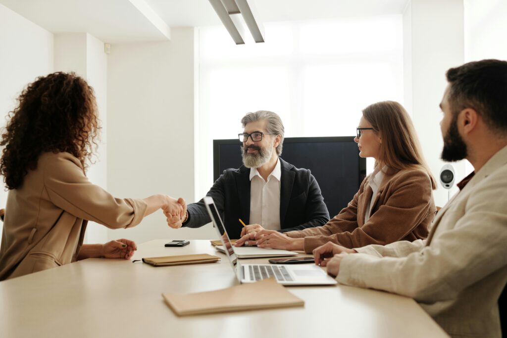 HR team at a conference table - HR paperwork | Ongig Blog HR team at a conference table - HR paperwork