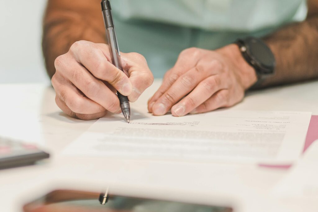 Person writing with pen on paper | Ongig Blog Person writing with pen on paper