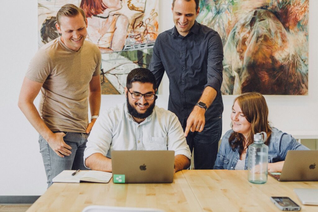 people at laptop in office